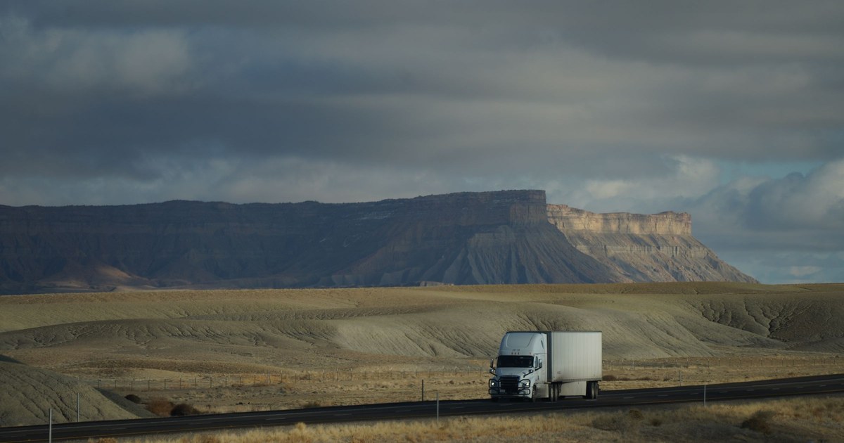 A tractor-trailer on an open highway.